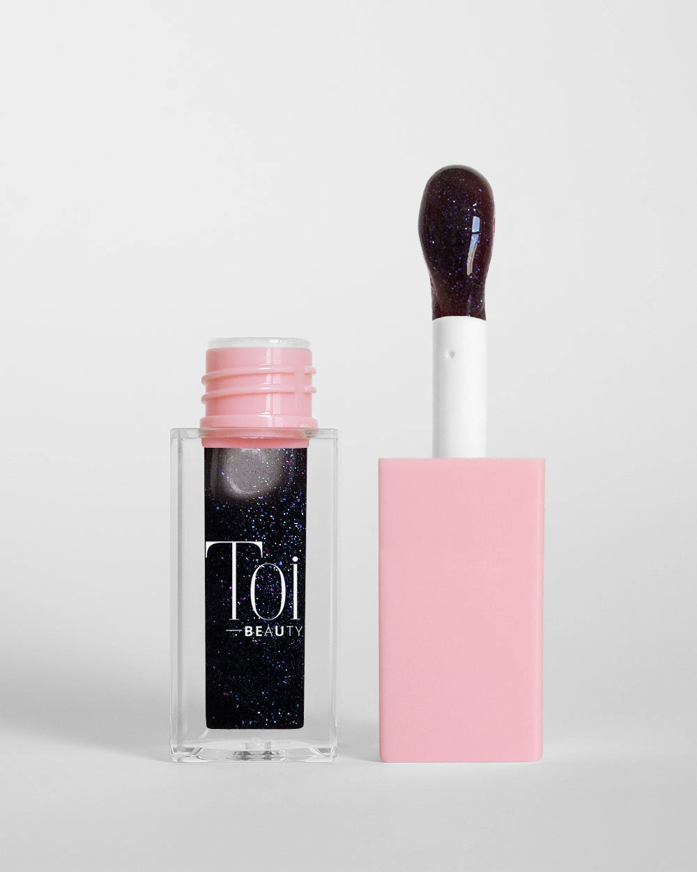 Tinted lip oil in clear packaging for everyday wear. Color Berry Noir