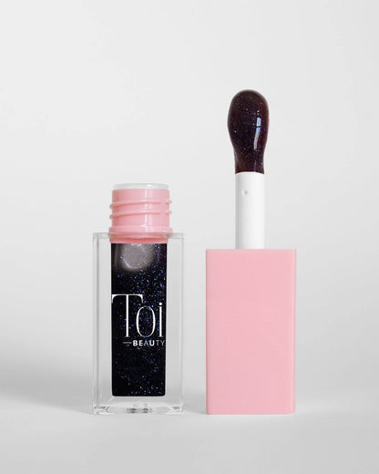 Tinted lip oil in clear packaging for everyday wear. Color Berry Noir